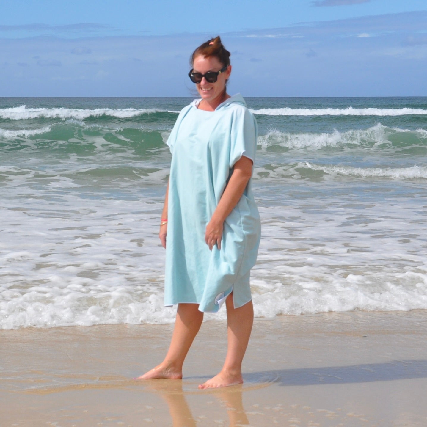 Adult wearing Aqua Lagoon sand-free beach hoodie showing comfort and style.
