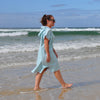 Adult wearing Aqua Lagoon sand-free beach hoodie showing comfort and style.