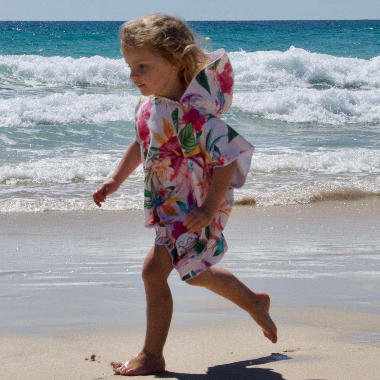 Island Princess - Sand-Free Beach Hoodie - Sandi Toes running on the beach in a small sand free hoodie