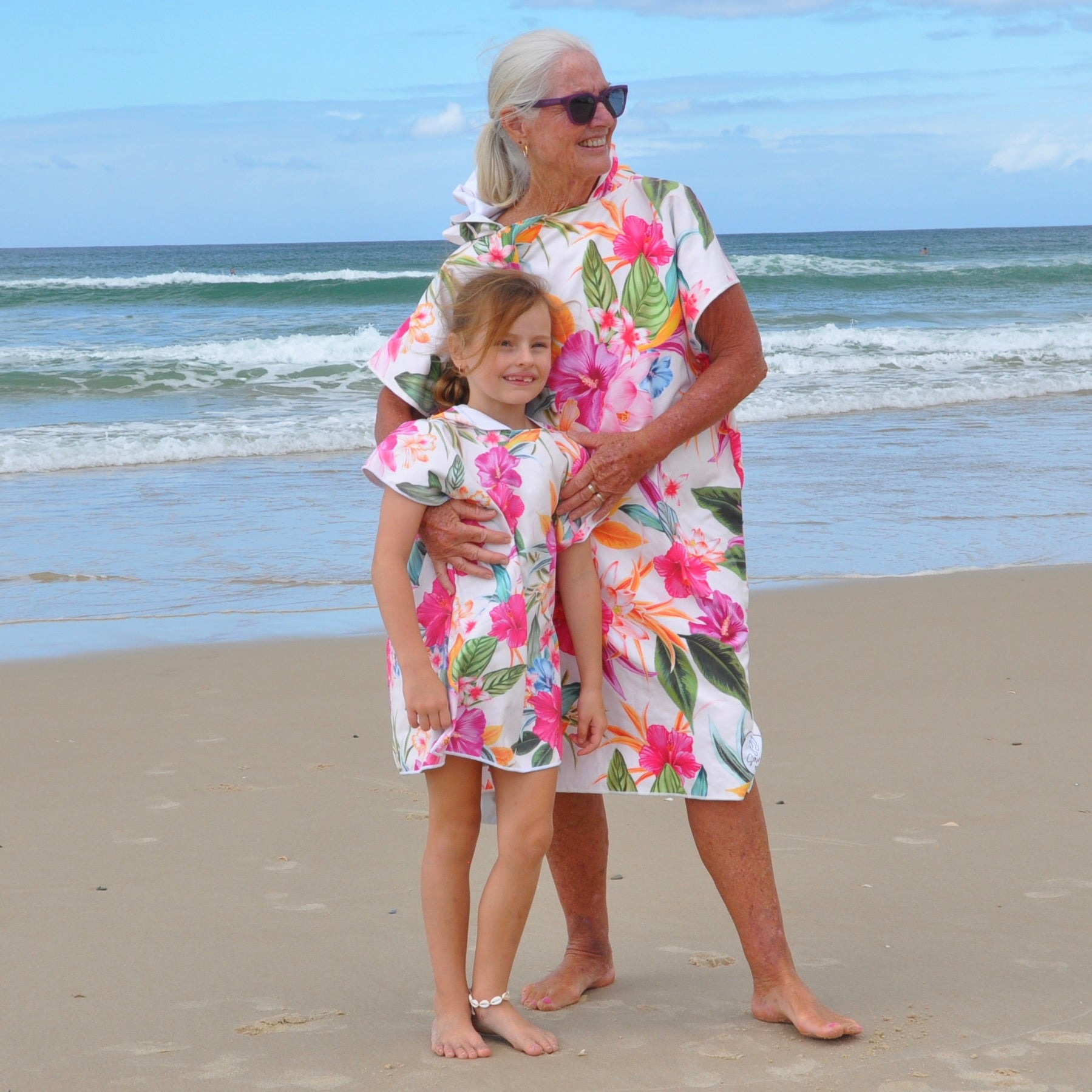 "Island Princess sand-free hoodie - Grand Mother and grand daughter wearing matching adult and kids hoodies in happy mood on beach"