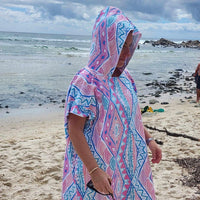 Adult wearing Xalli sand-free beach hoodie showing comfort and style, with hood up