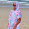 Adult wearing Xalli sand-free beach hoodie showing comfort and style, with hood up