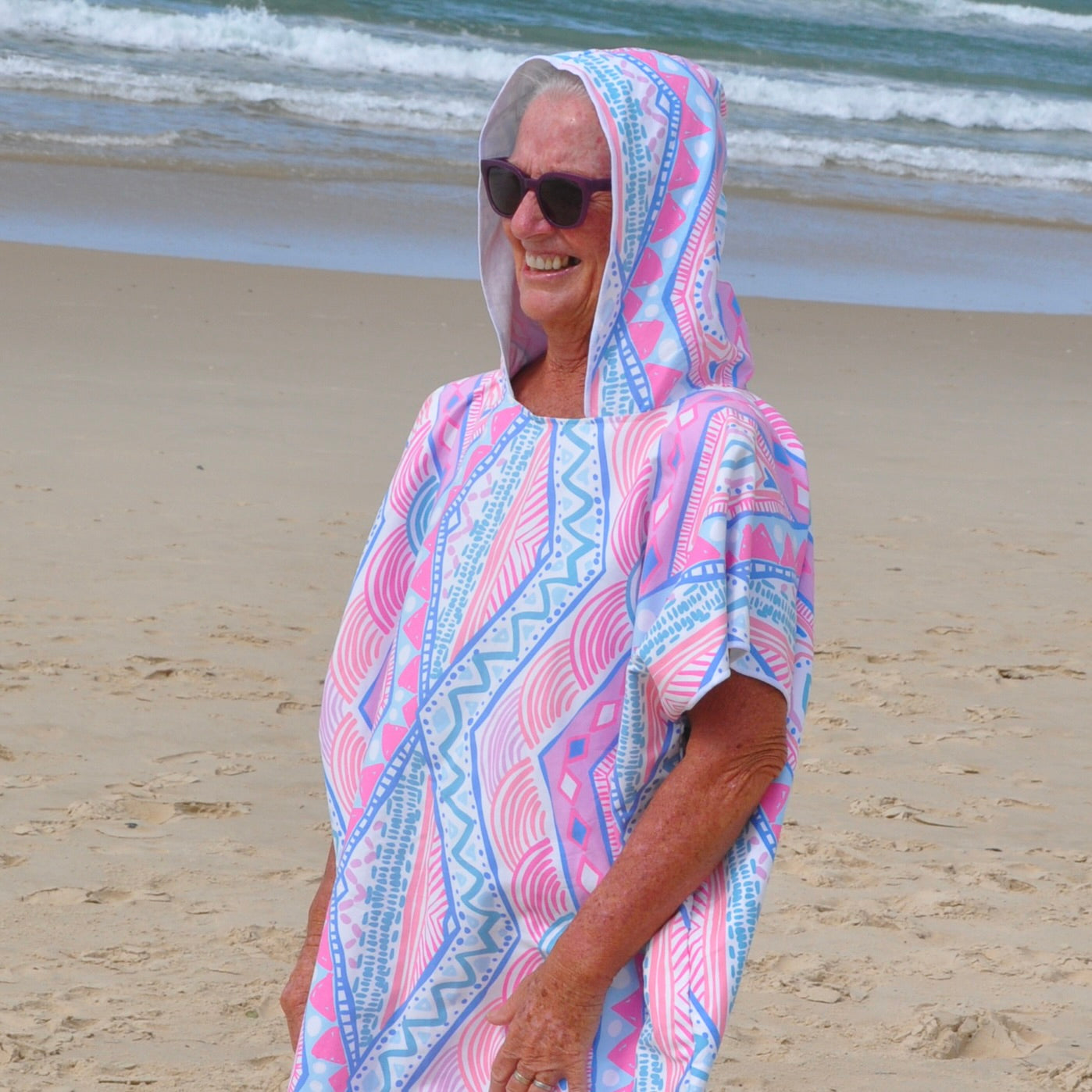 Adult wearing Xalli sand-free beach hoodie showing comfort and style, with hood up